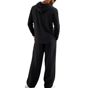 Back view of a black linen men's casual two-piece set with a hooded long-sleeve shirt