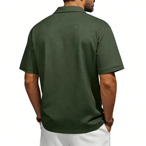 Close-up rear view of a men's vintage washed green polo shirt with textured fabric