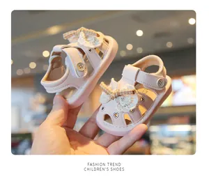 Detailed view of pink baby summer sandals with hollow heart design and lace bow
