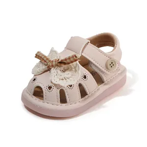 Elegant pink hollow-out baby summer sandals featuring a lace bow and soft breathable sole