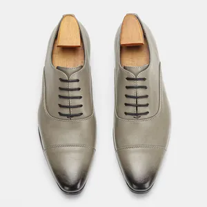 Top-down view of classic gray leather Oxford shoes with elegant wood shoe trees