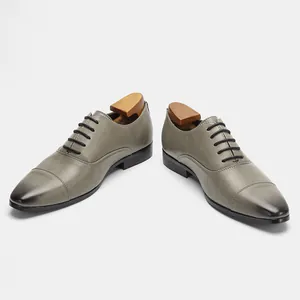 Elegant gray leather Oxford shoes for men featuring classic lace-up design and burnished toe
