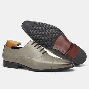 Close-up of grey leather Oxford shoes showcasing the non-slip sole and vintage texture.