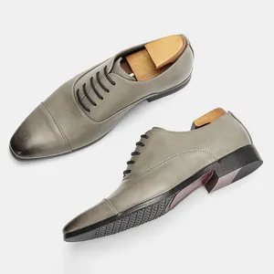 Close-up of grey vintage men's Oxford shoes with burnished toe and professional shoe trees