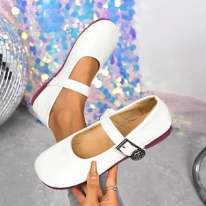 Detailed macro view of stylish white retro Mary Jane flats with rose-engraved buckle