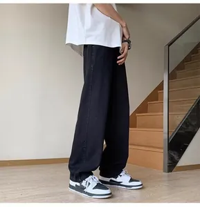 Men's loose straight black jeans in high street style shown in full length