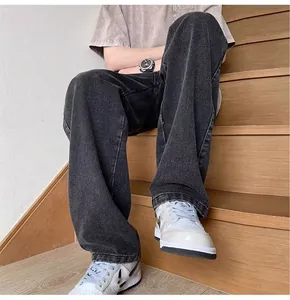 Close-up detail of high street style loose straight-leg washed denim jeans for men