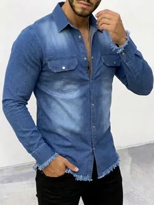 Detail view of men's washed blue denim shirt with raw frayed edges and snap button pockets.