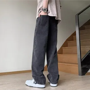 Detail view of mens baggy straight jeans in washed dark grey denim high street style