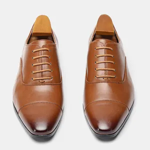 Top-down view of brown leather Oxford shoes with wooden shoe trees
