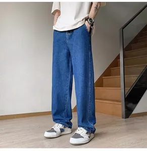 Full view of men's loose straight-leg denim jeans in vintage blue wash on model
