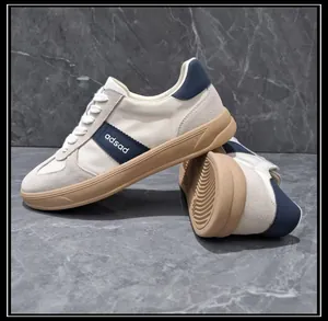 Detail view of men's leather and fabric sneakers with non-slip tan rubber sole
