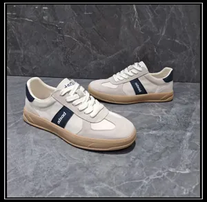 Side view of men's leather and fabric patchwork German Army Trainer sneakers in beige