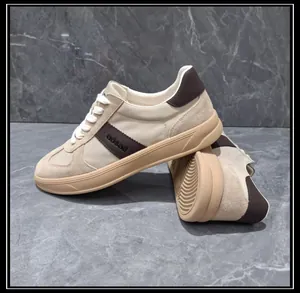 Side detail of men's cream and brown leather-spliced casual GAT sneakers with tan sole