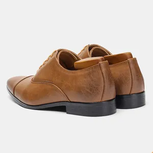 Back view detail of classic brown men's Oxford dress shoes with vintage texture