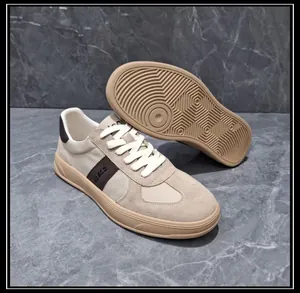 Detail of beige men's GAT sneakers showing side patchwork and textured rubber sole pattern.