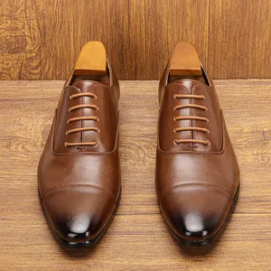 Detailed view of classic brown men's oxford shoes with cap-toe and burnished finish