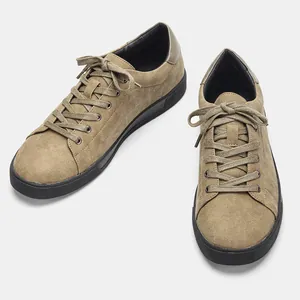 Detalle de las elegantes zapatillas casuales de ante caqui para hombre con suela de goma