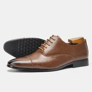 Detailed view of brown men's leather Oxford shoes featuring classic business formal design.