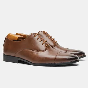 Detailed side view of classic brown men's oxford shoes with elegant cap toe design