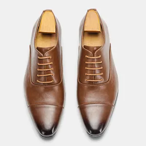 Top view of classic brown leather Oxford dress shoes with vintage gradient toe detail