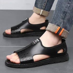 Close-up of black men's hollow-out sandals showing breathable design and fit on feet.
