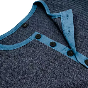 Close-up of men's blue ribbed Henley shirt neckline with contrast trim and black buttons