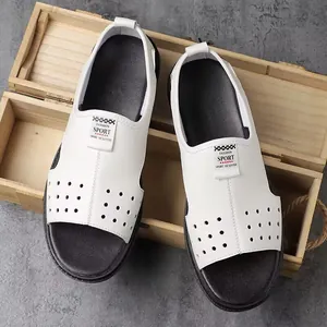 Top view detail of white men's breathable hollow sandals on wooden background