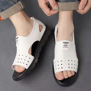 Top-down view of men's white hollow-out Roman sandals on feet