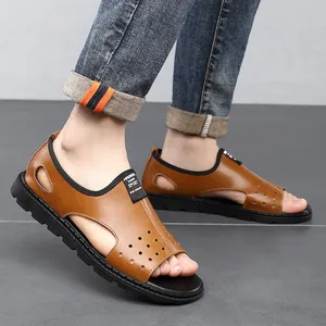 Close-up view of men's stylish brown hollow-out breathable beach sandals for summer.