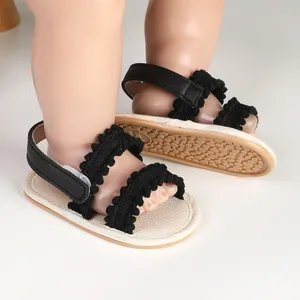 Detailed view of breathable black baby sandals with soft non-slip soles for infant girls