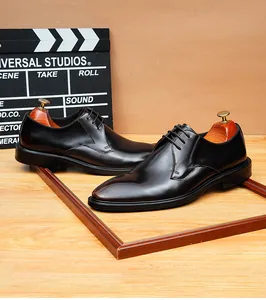 Detail of black leather business dress shoes with retro polished finish and lace-up design
