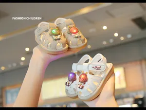Detail view of toddler light-up sandals with cartoon astronaut charms and LED soles