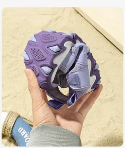Close-up showing the flexible and soft rubber sole of purple children's beach sandals