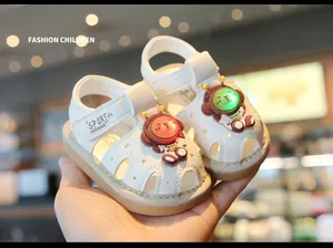 Detail of white baby sandals with LED light-up bear characters for toddlers 0-2 years