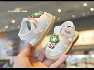 Close-up of white baby sandals with glowing cartoon bear decoration and soft sole