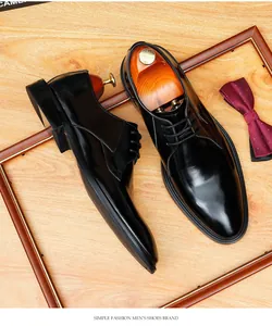 Close-up detail of black leather business shoes with polished finish and wooden shoe trees.