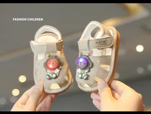 Close-up of baby light-up sandals with cartoon bear astronaut and glowing LED lights