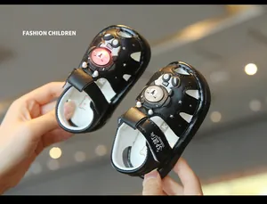 Detail of black toddler light-up sandals with cartoon bear design and LED light
