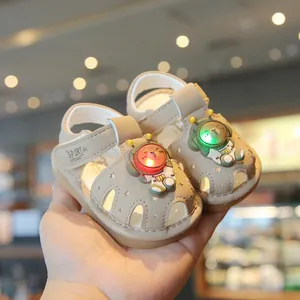 Comfortable LED light-up baby walking sandals with cute astronaut bear design in beige