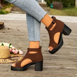 Detail shot of brown cutout high-heeled Roman sandals with chunky heel and back zipper.