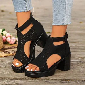 Stylish black chunky heel sandals featuring intricate hollow-out floral patterns on feet