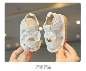 Détail de sandales blanches pour bébés filles avec un charmant nœud et de la dentelle