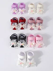 Seven pairs of infant girl soft sole princess shoes with lace bows in assorted colors