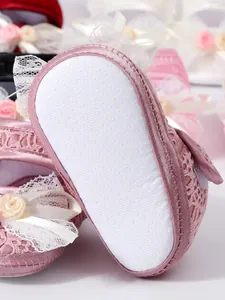 Detailed view of pink baby princess walker shoes featuring white non-slip soft rubber soles