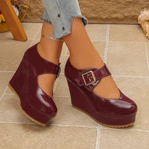 Close-up detail of stylish burgundy patent leather platform wedge Mary Jane shoes