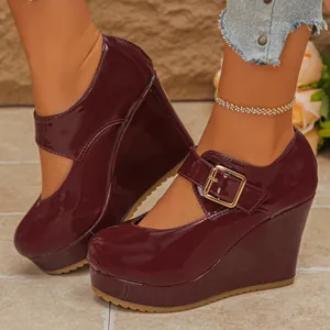 Detailed view of burgundy patent leather wedge Mary Jane shoes with platform and square toe