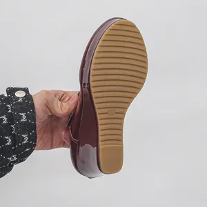 Detailed view showing the non-slip ridged rubber sole of a burgundy wedge Mary Jane shoe