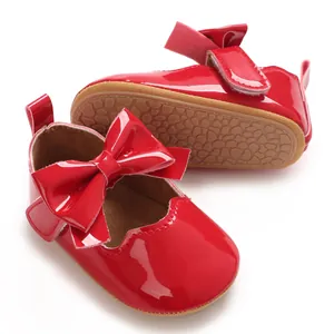 Vue détaillée de chaussures de marche pour bébé en cuir verni rouge avec nœud et semelle