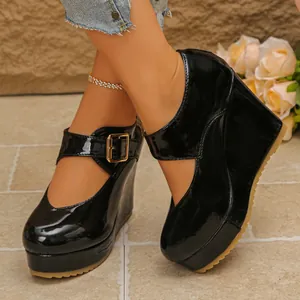 Elegant black patent leather Mary Jane wedge shoes featuring a high platform and square toe